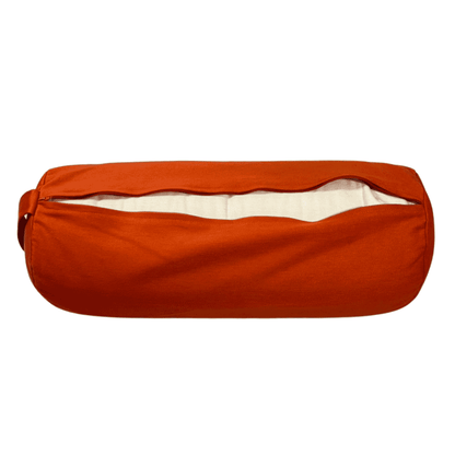 A terracotta orange bolster unzipped showing the inner casing containing buckwheat